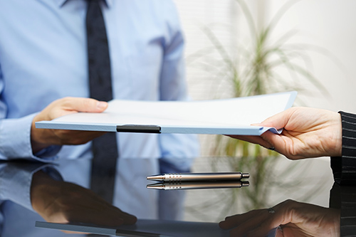 businessman is passing signed agreement to client after successf